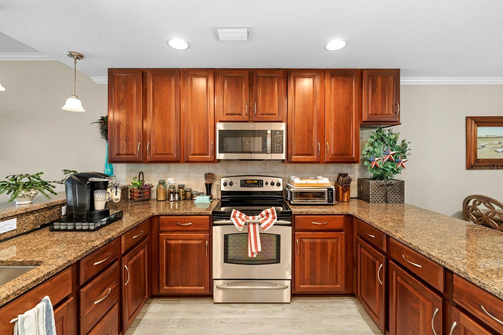 The kitchen features granite counters, 42" cabinets, all stainless steel appliances, updated lighting, and a gorgeous view from the kitchen sink.