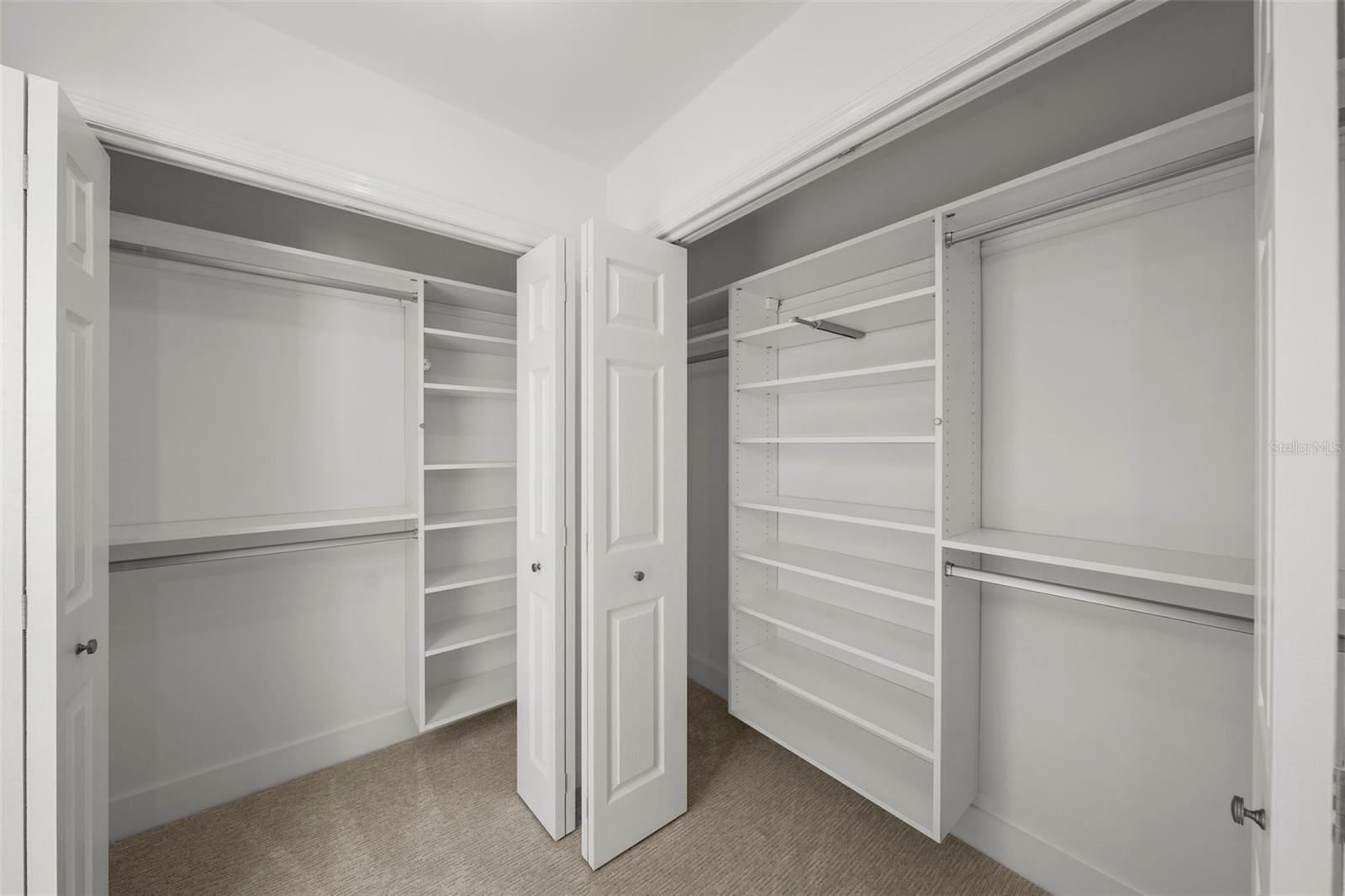 Walk through closets with custom shelving and valet rods