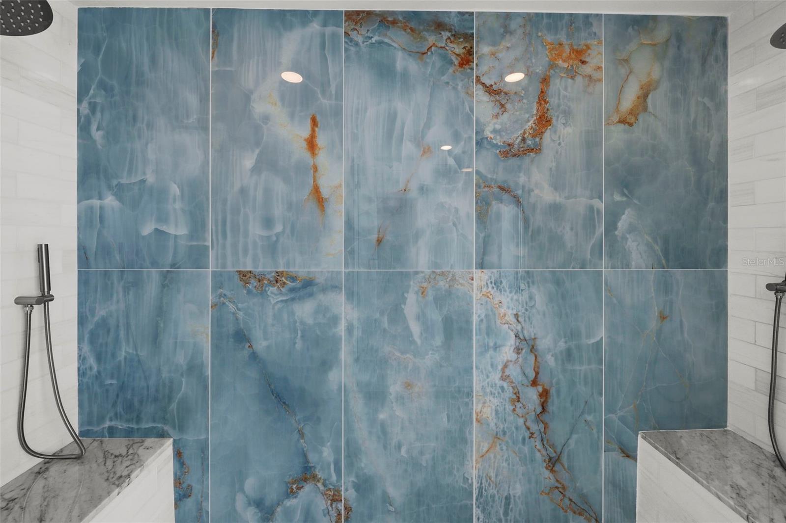 Spa like shower with dual benches and dual luxury shower heads