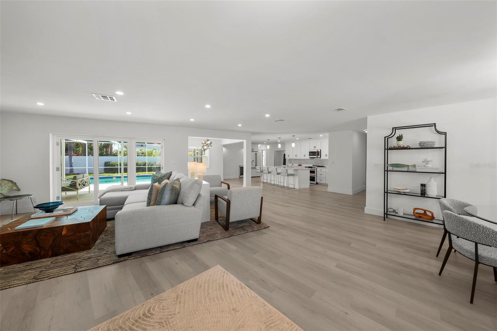 View of the flow upon entering - family room in front, dining room to the right, kitchen in the distance