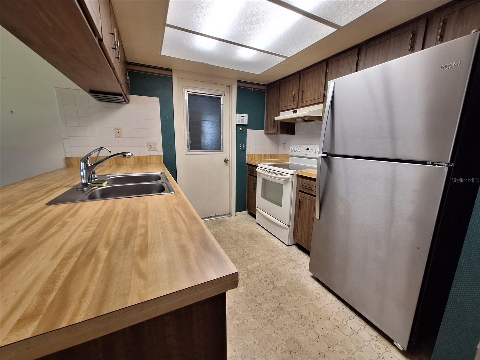 Butcher Block Countertops and Stainless Frig and Dishwasher