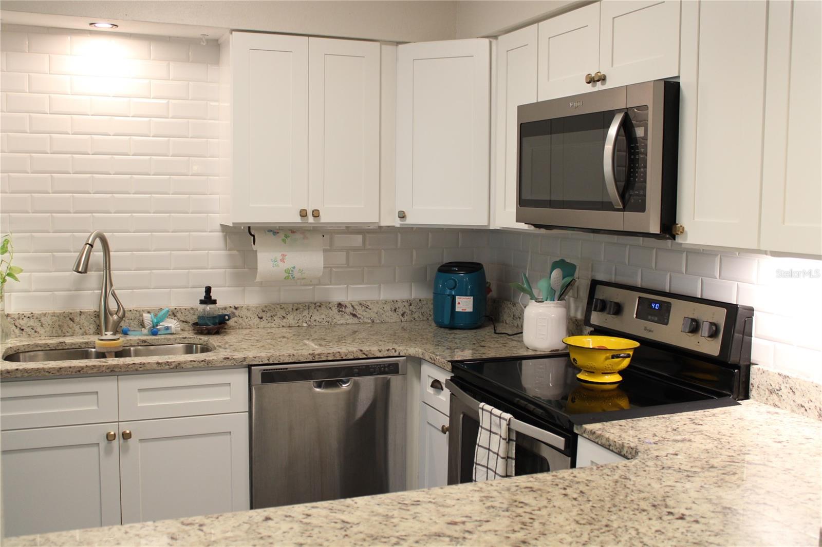 Beautiful Quartz counter tops and Subway tile backsplash.