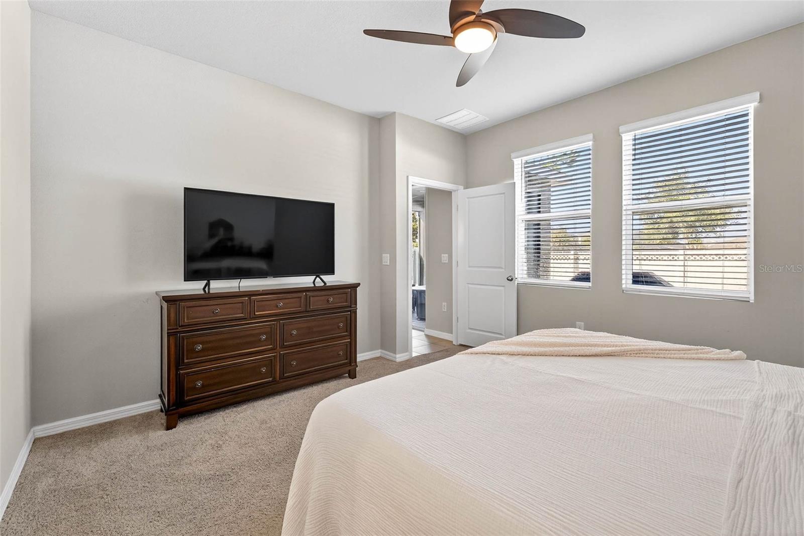 Primary suite has view of the back yard.