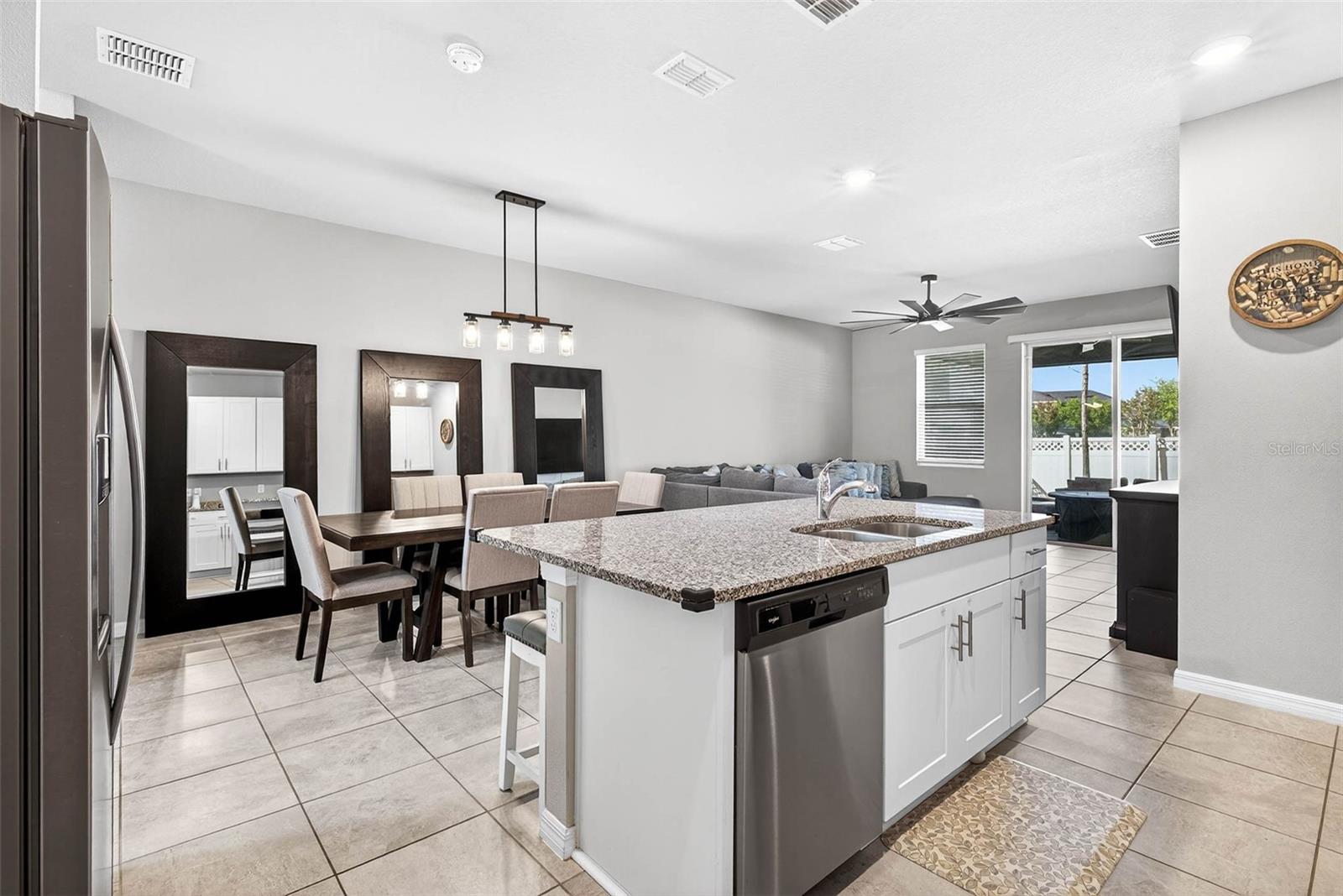 Dining area has overhead lighting fixture and room for a table of 6+.
