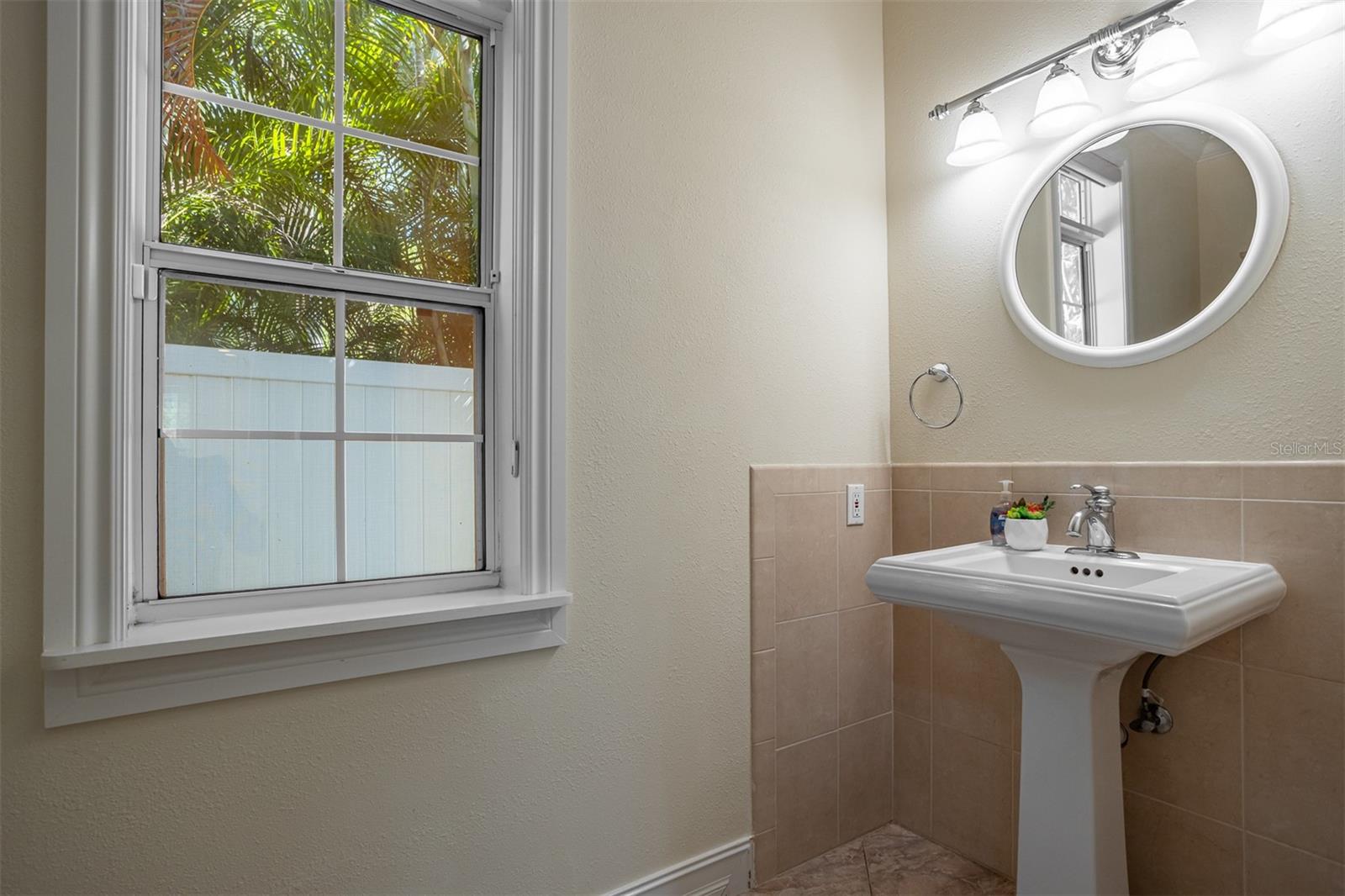 Beautiful spacious powder room off main living area with pedestal sink