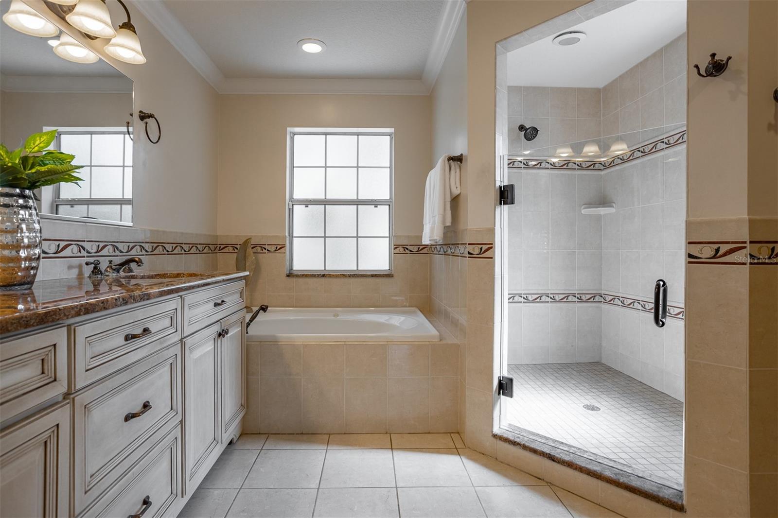 Primary Bathroom with large walk in shower, soaker tub and double sinks