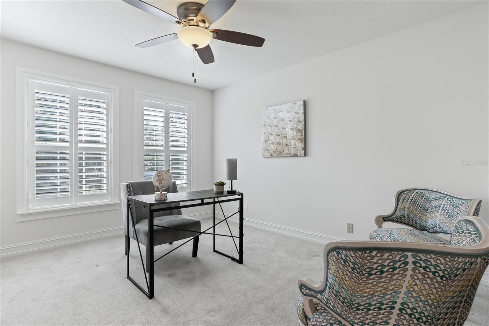 Bedroom No. 2 with custom shutters, closet and is currently set up as an office