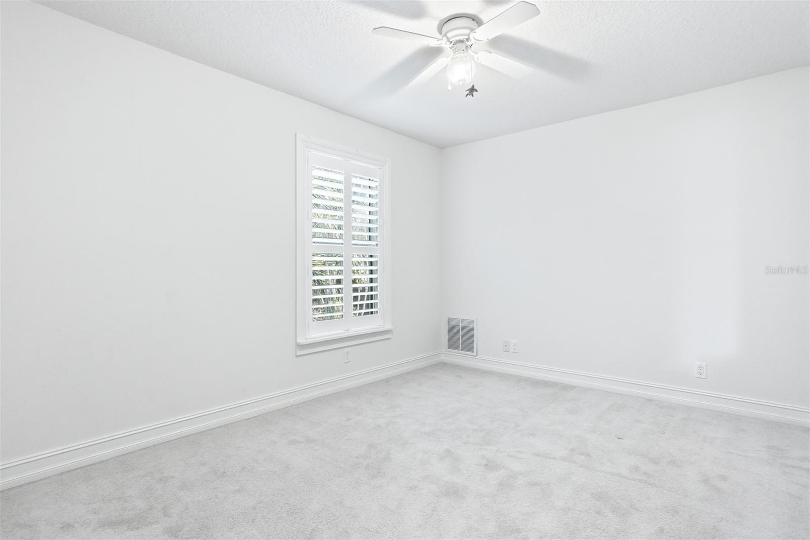Bedroom No. 3 with custom shutters and built in closet