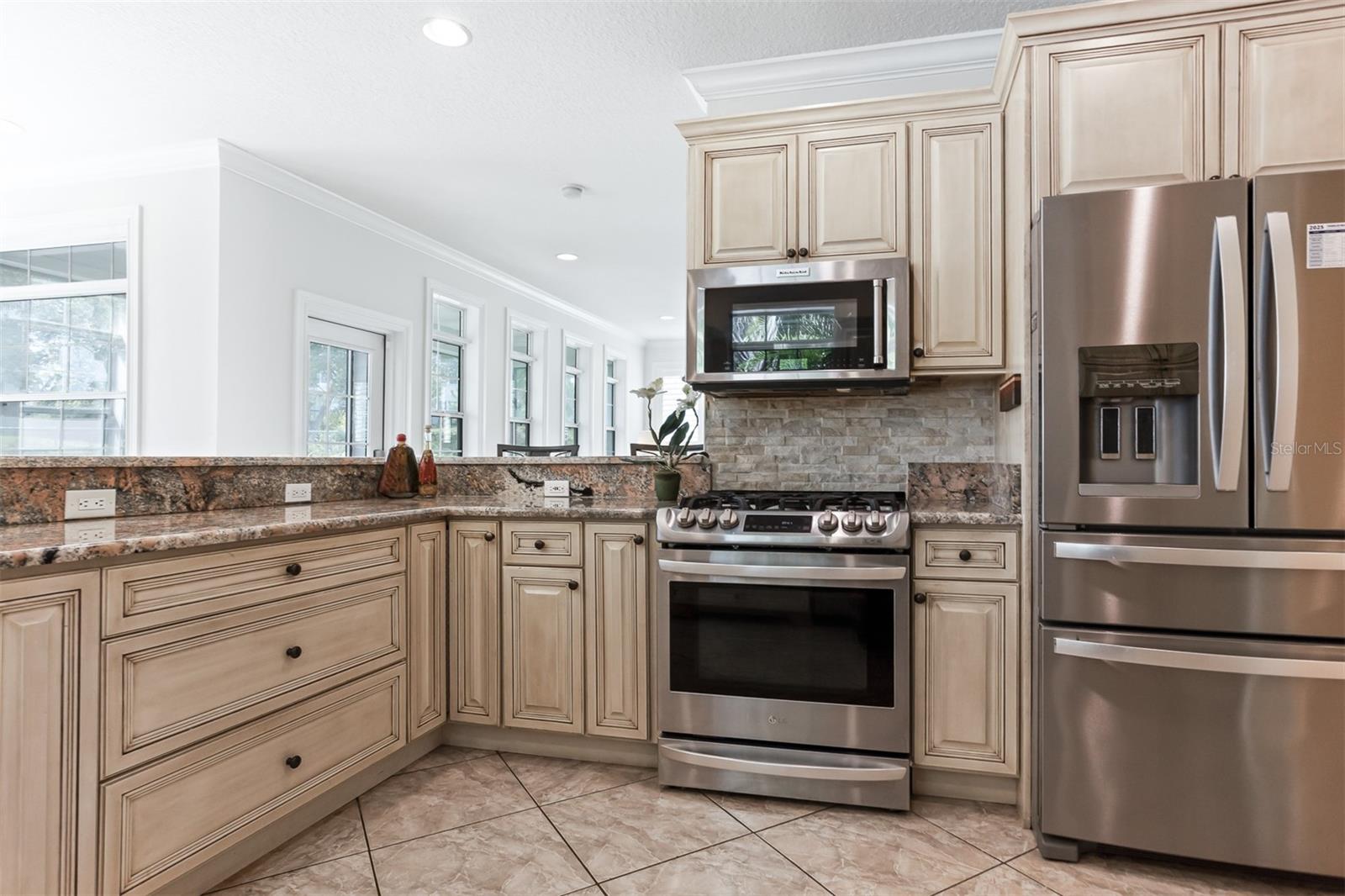 Fantastic chefs kitchen with Natural Gas, Stainless Steel Appliances, magnetic knife holder, double sink, dining bar, built in pantry closet, breakfast area and so much more