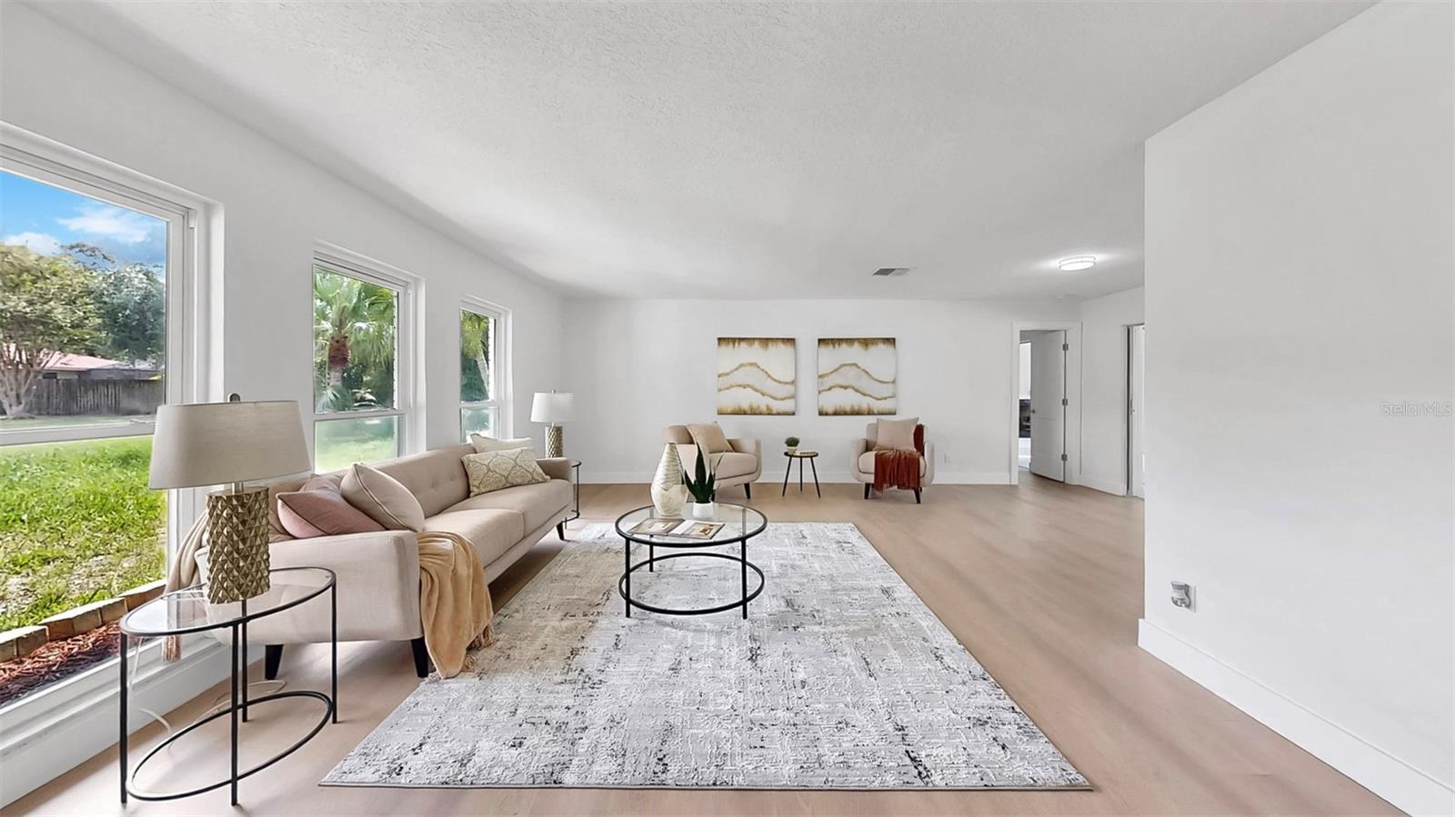 Formal Living room over looking lush front yard.