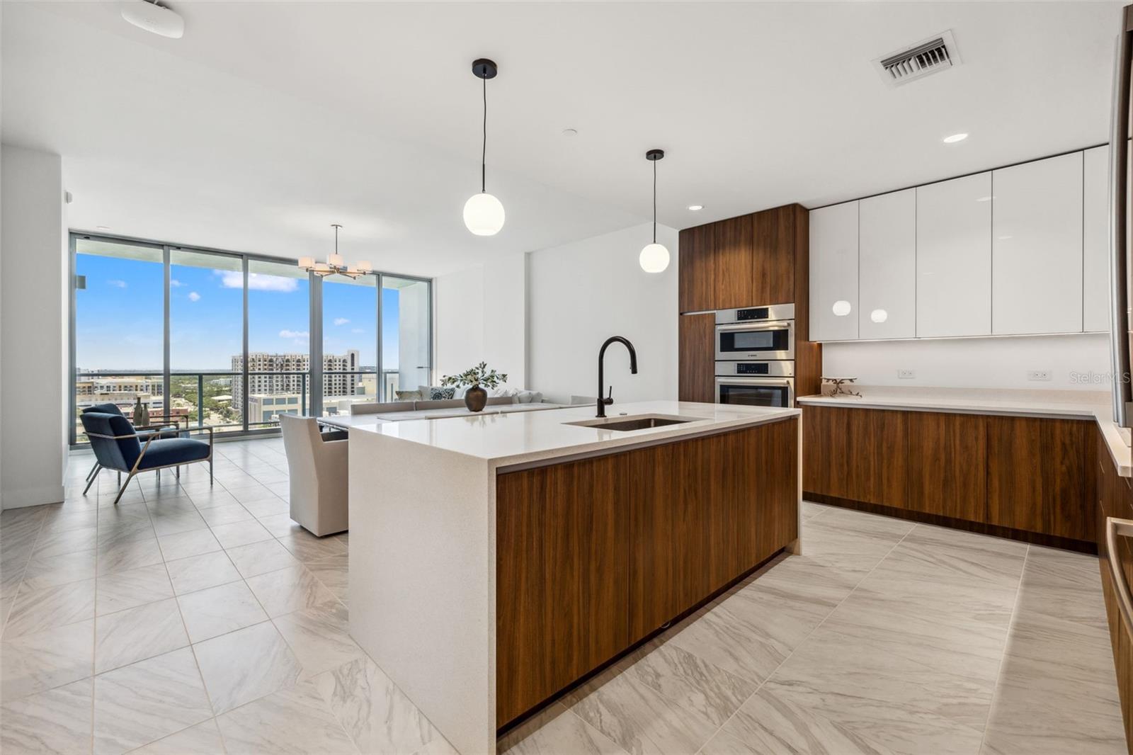Chef's dream kitchen with expansive island with with kitchen sink so you're always looking out at the view!