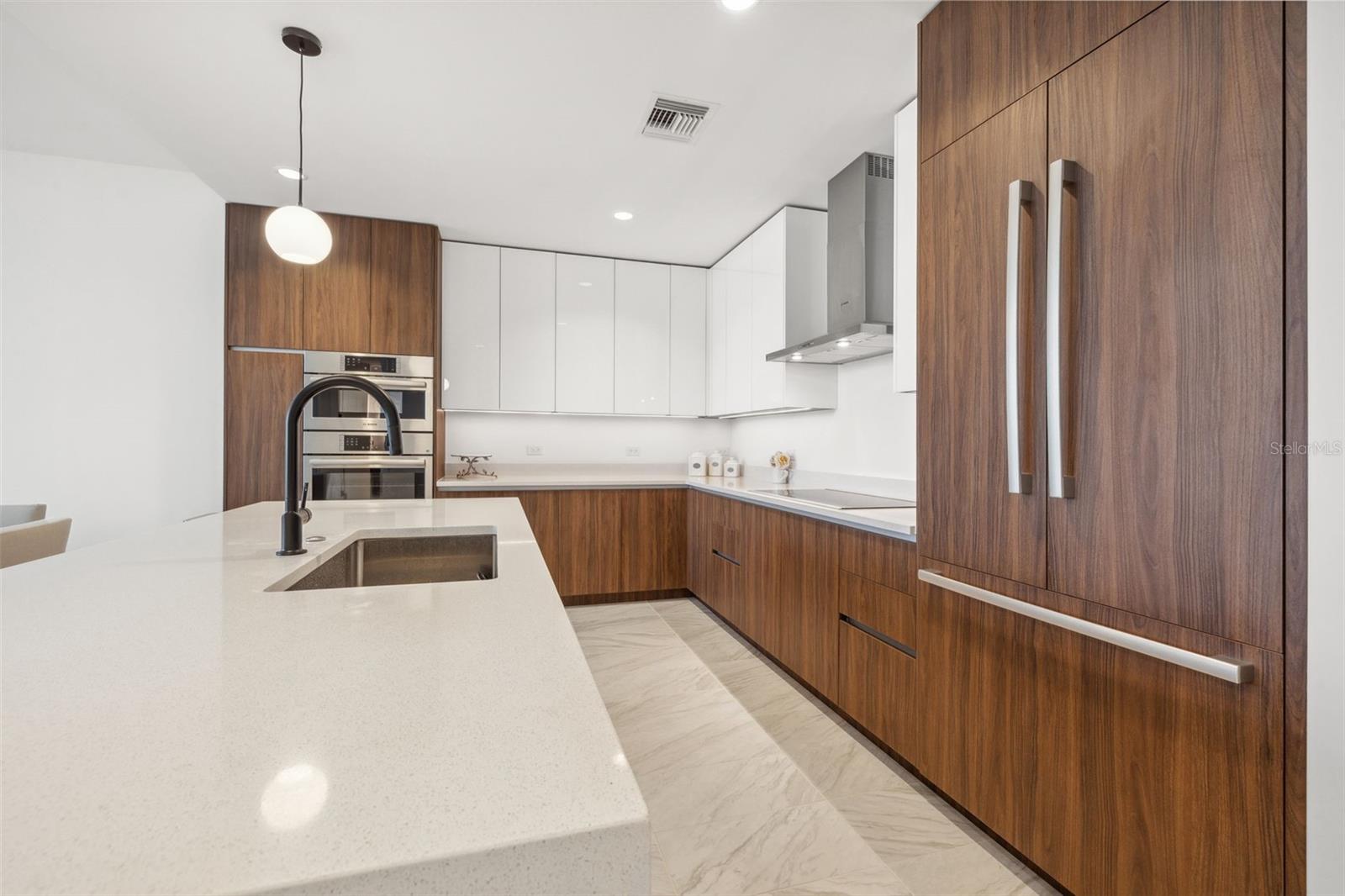 Stainless steel panel ready Bosch appliances and Italkraft walnut cabinetry