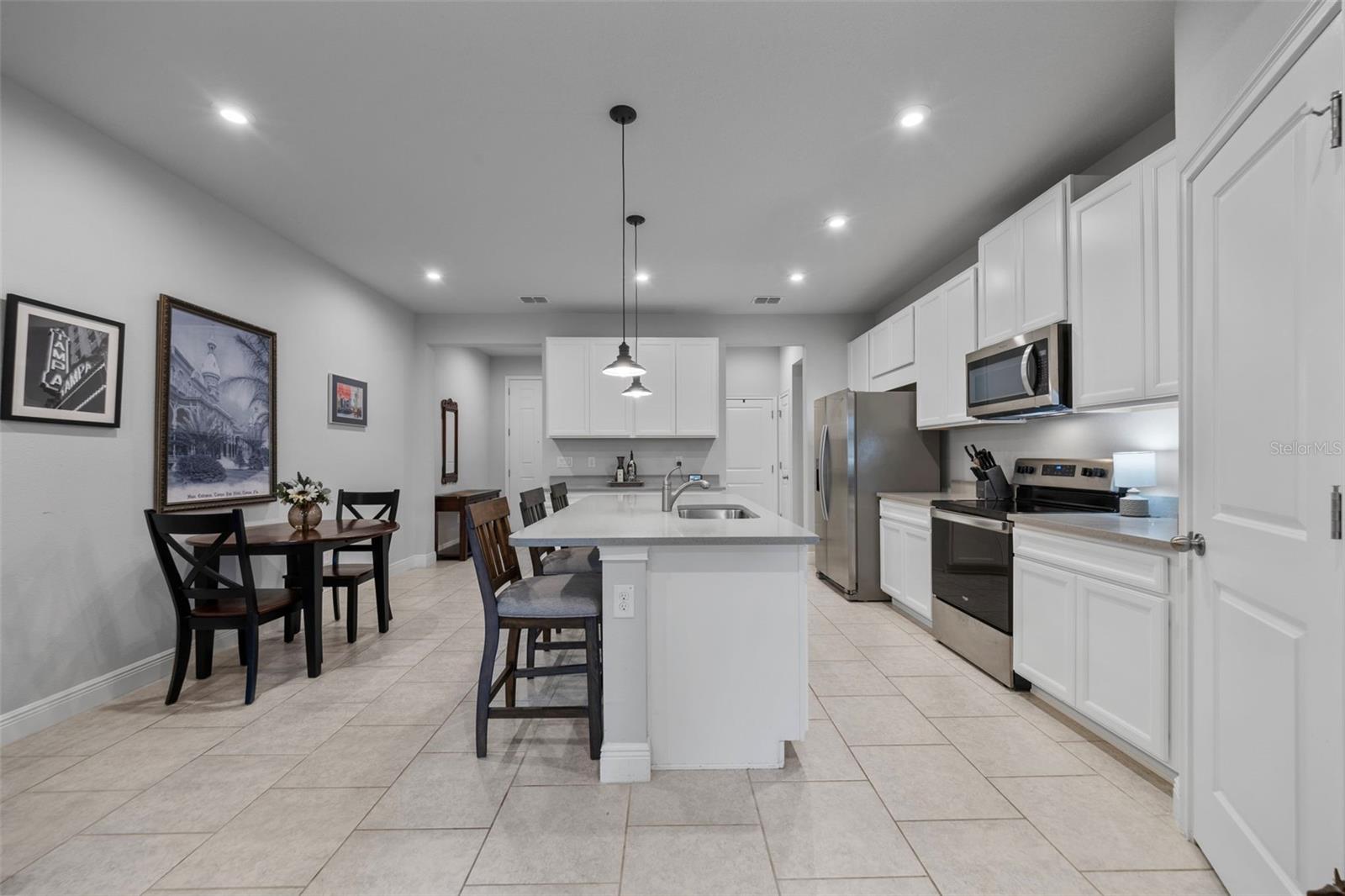 Kitchen with view of front door and access door to garage