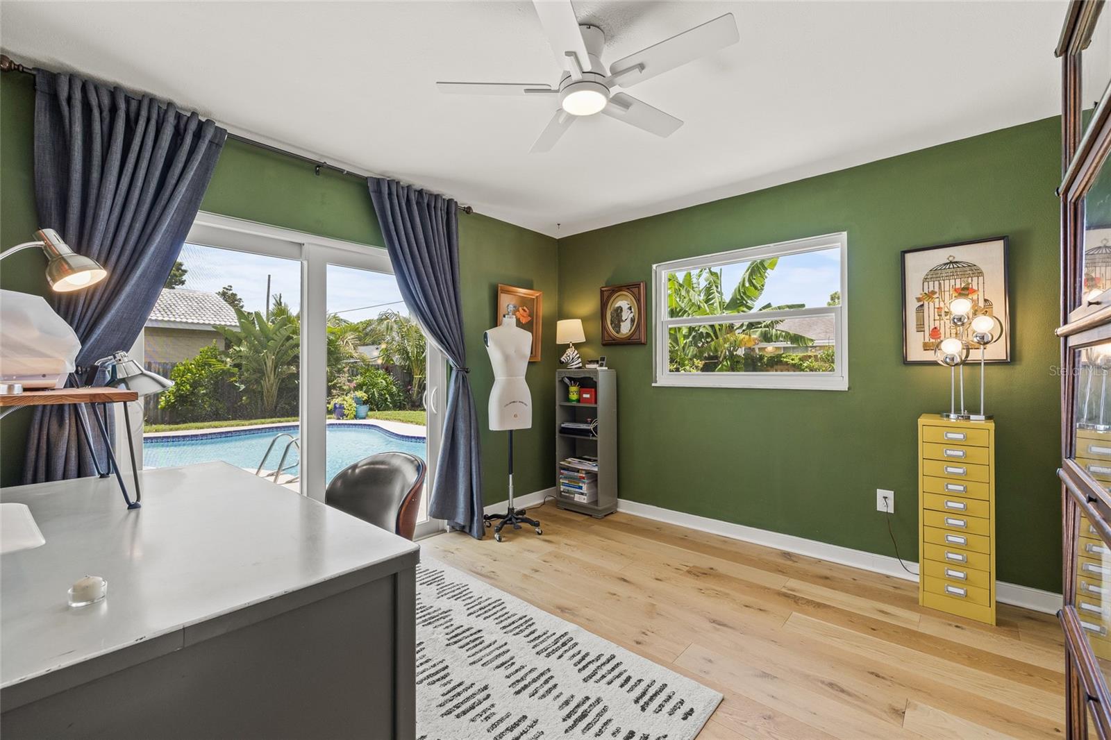 Bedroom 2 with doors to pool area