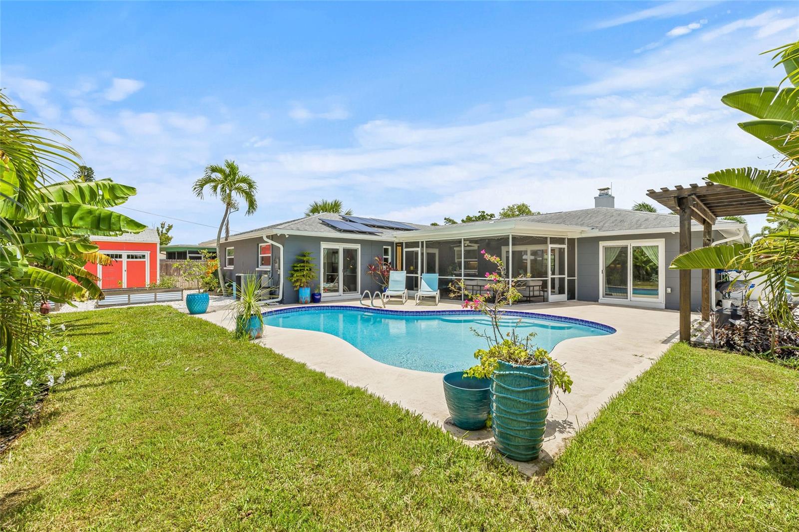 Large rear yard with tropical landscaping