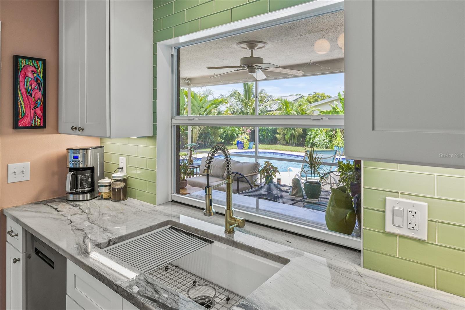 Kitchen overlooks pool and lanai