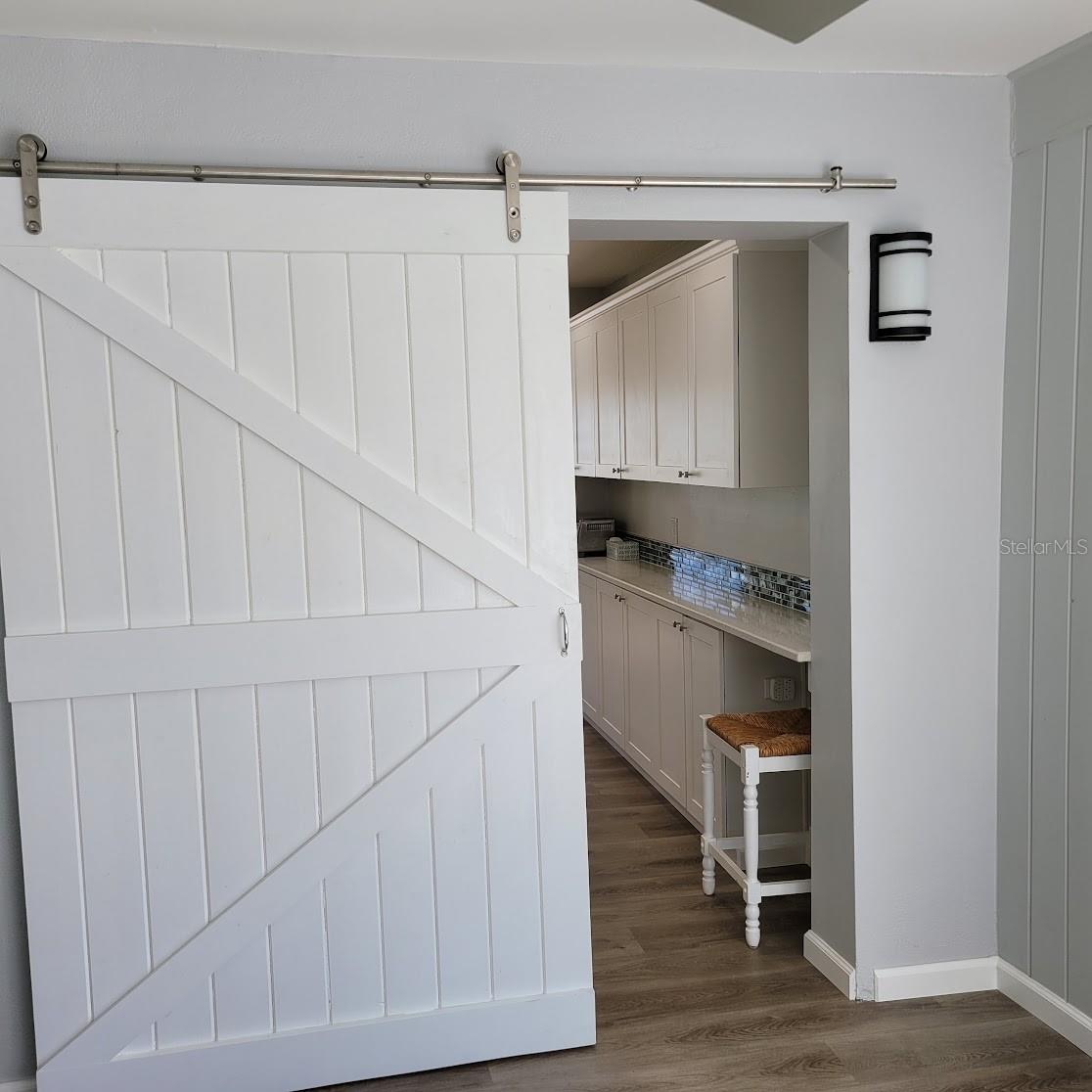 Between the kitchen and the multipurpose back room is a barn door to close off the room for privacy should you choose to use it as a bedroom, guest room, or office.