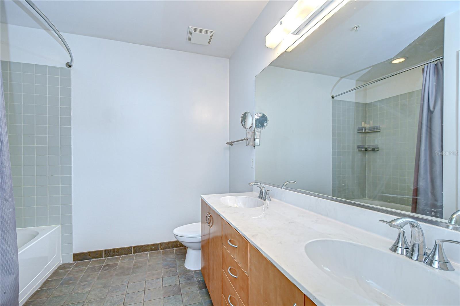 Primary bathroom has two sinks and shower/ tub combo!