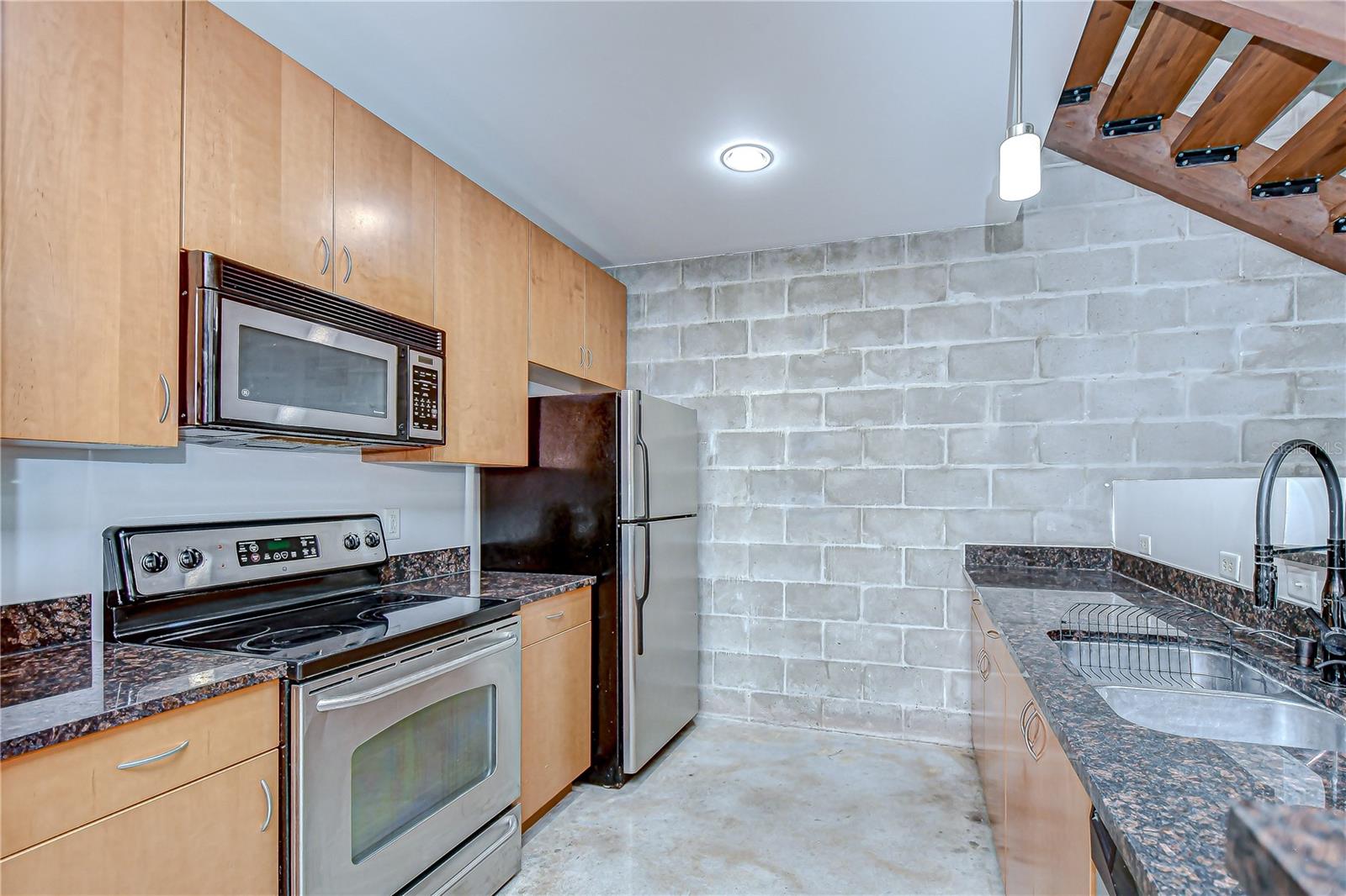 Kitchen features stainless appliances, generous cabinetry, and a breakfast bar!