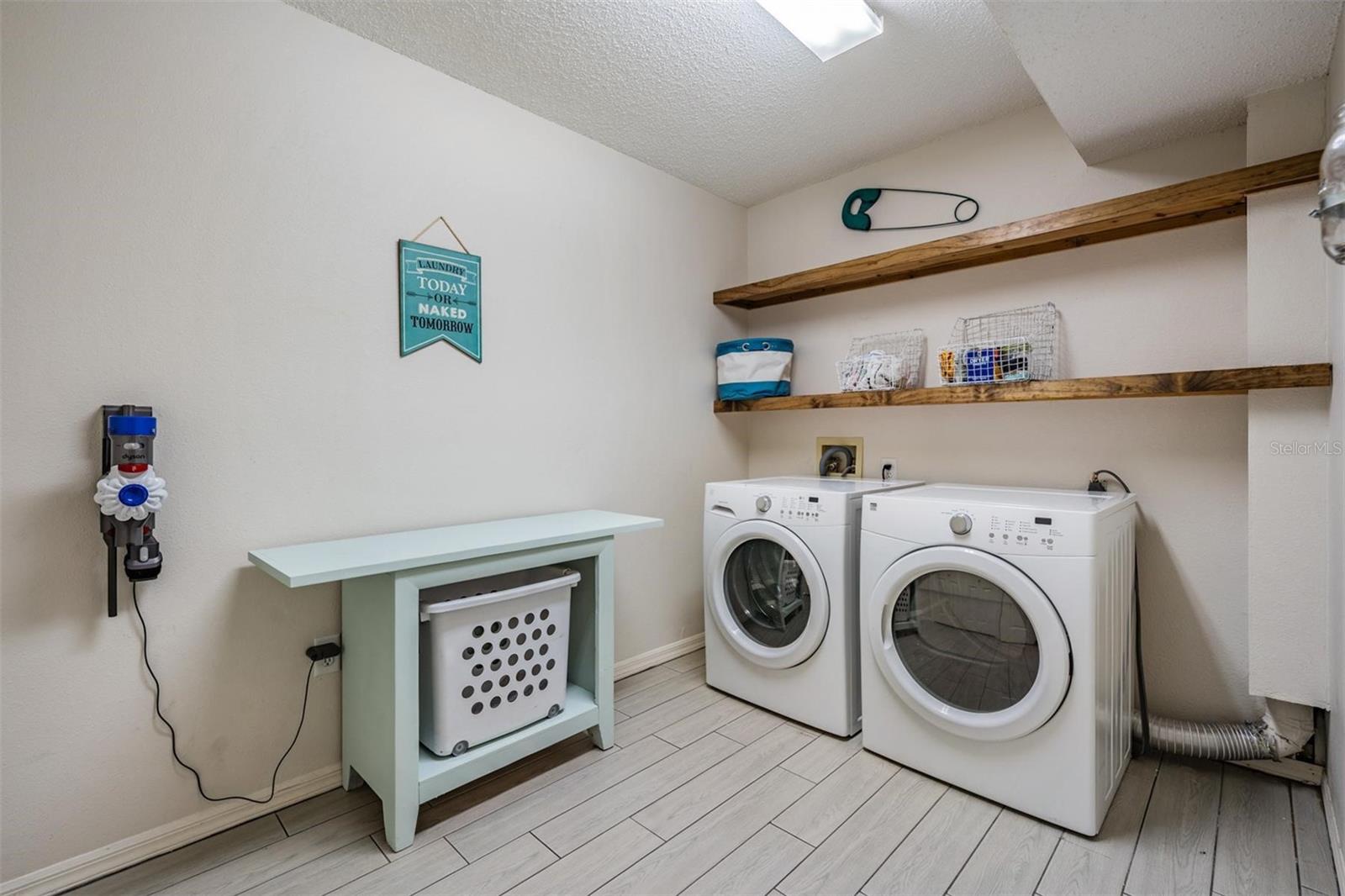 Oversized laundry room on first floor with large storage closet