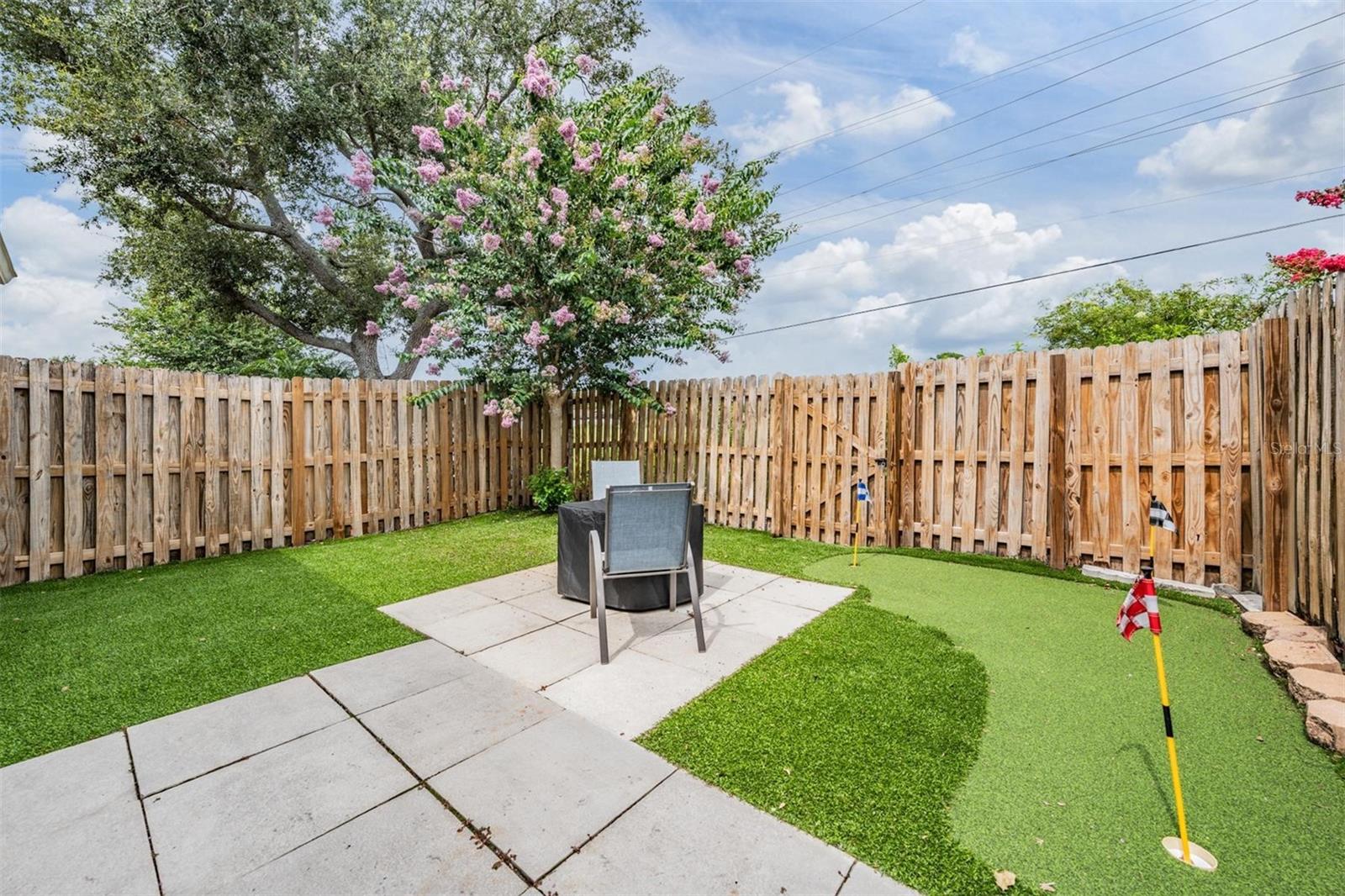 Paver fire pit area, fully turf lawn AND a putting green!