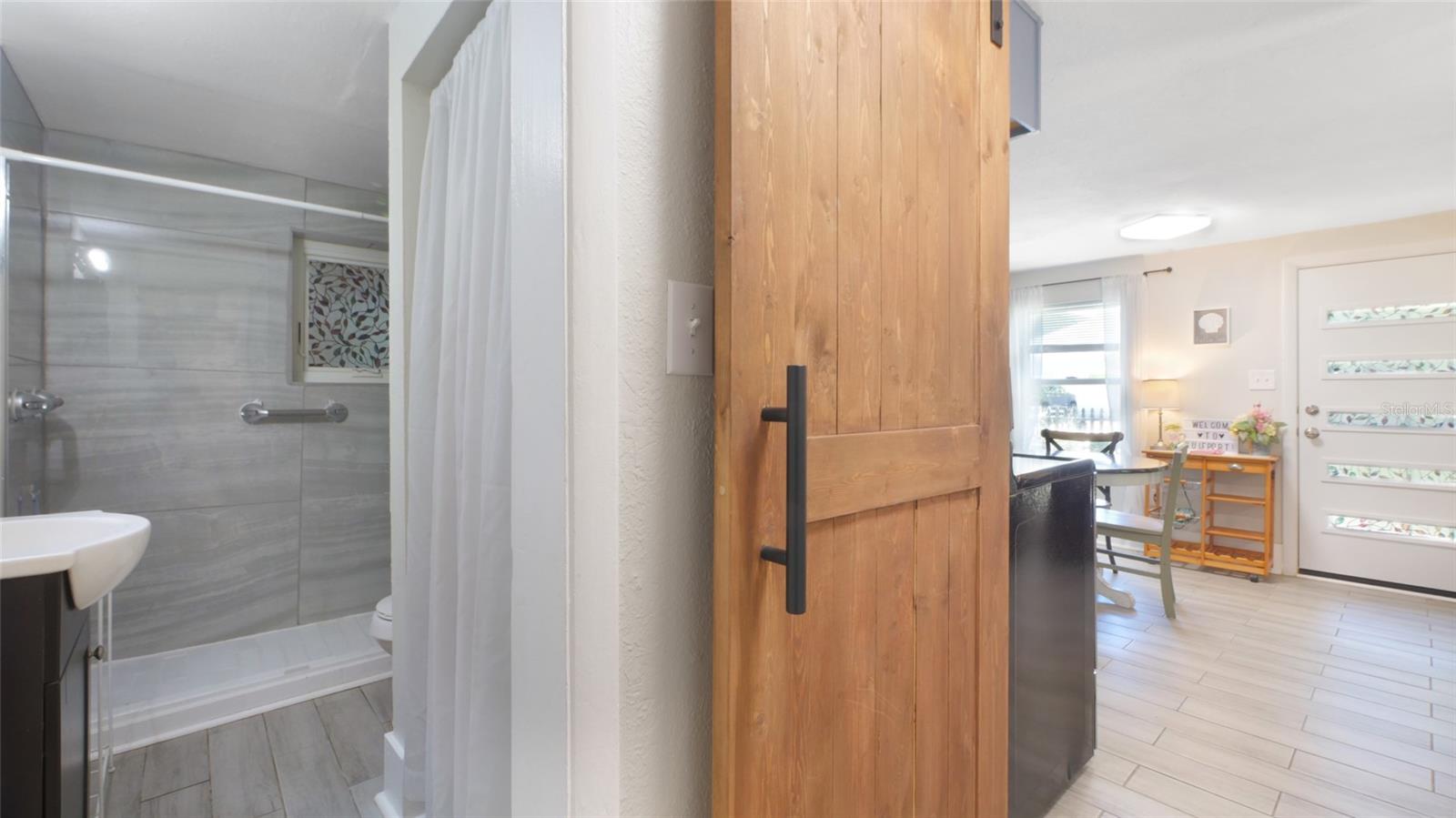 Functional and stylish barn door to the bathroom