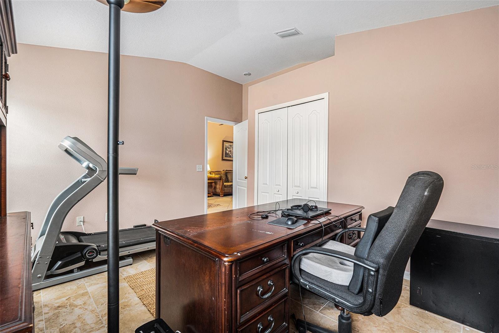 Backyard facing bedroom with built in closet