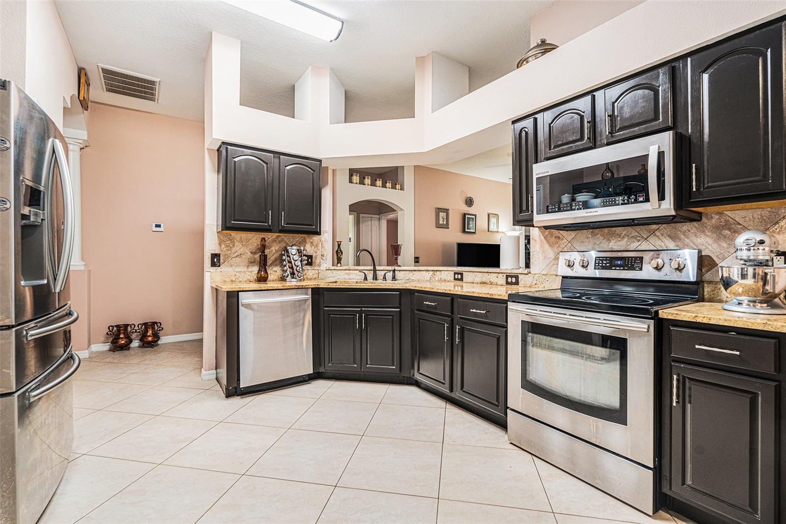 Dark wood cabinets, stainless steel appliances
