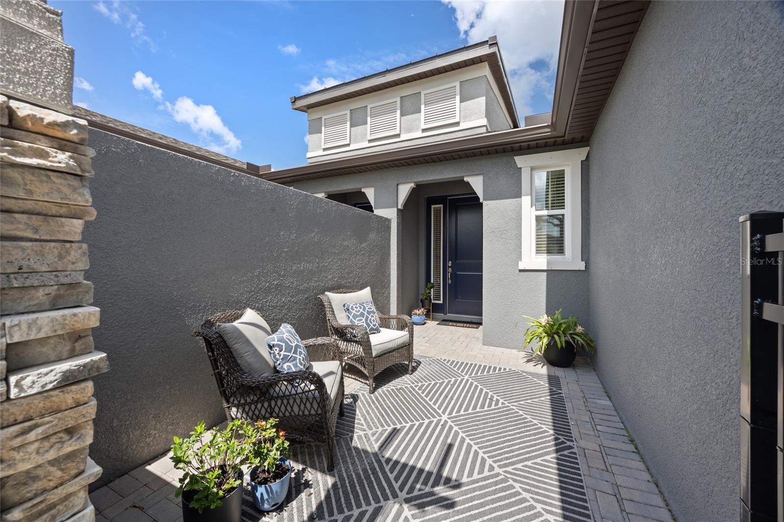 Private paver courtyard with seating.
