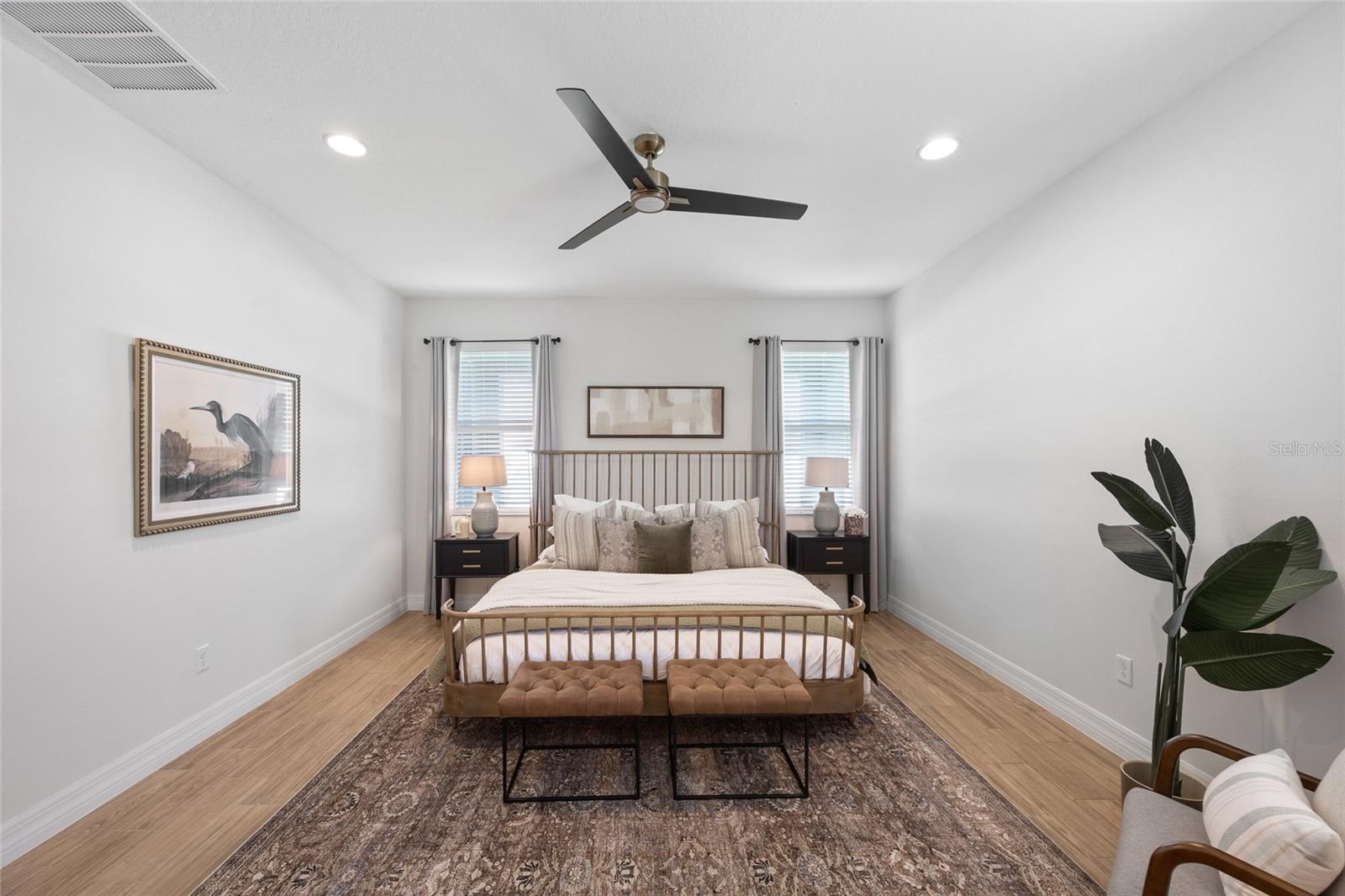 Relaxing primary suite with ample natural light.