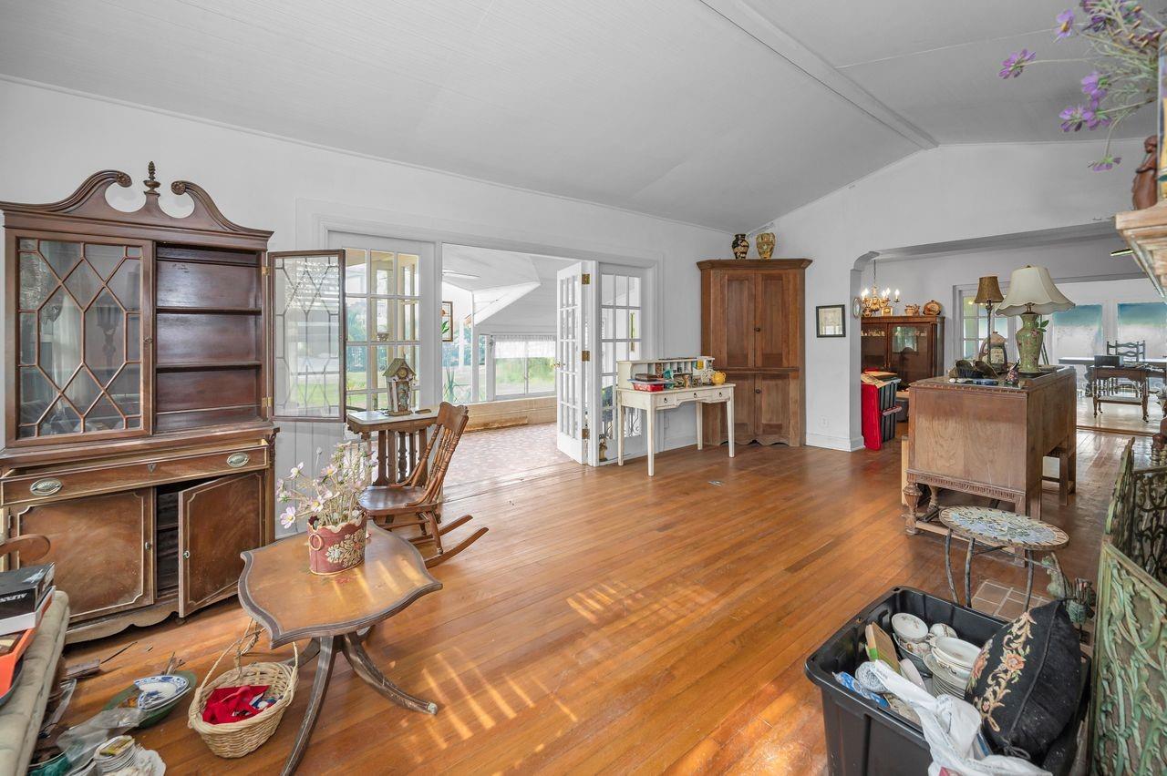 Living room with stunning hardwood floors, incredible views, plenty of natural light and amazing architectural details!