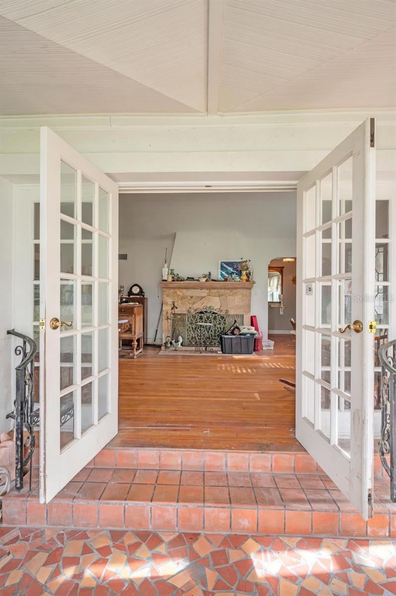 Looking from sunroom, imagine a roaring fire in this beautiful stone fireplace.