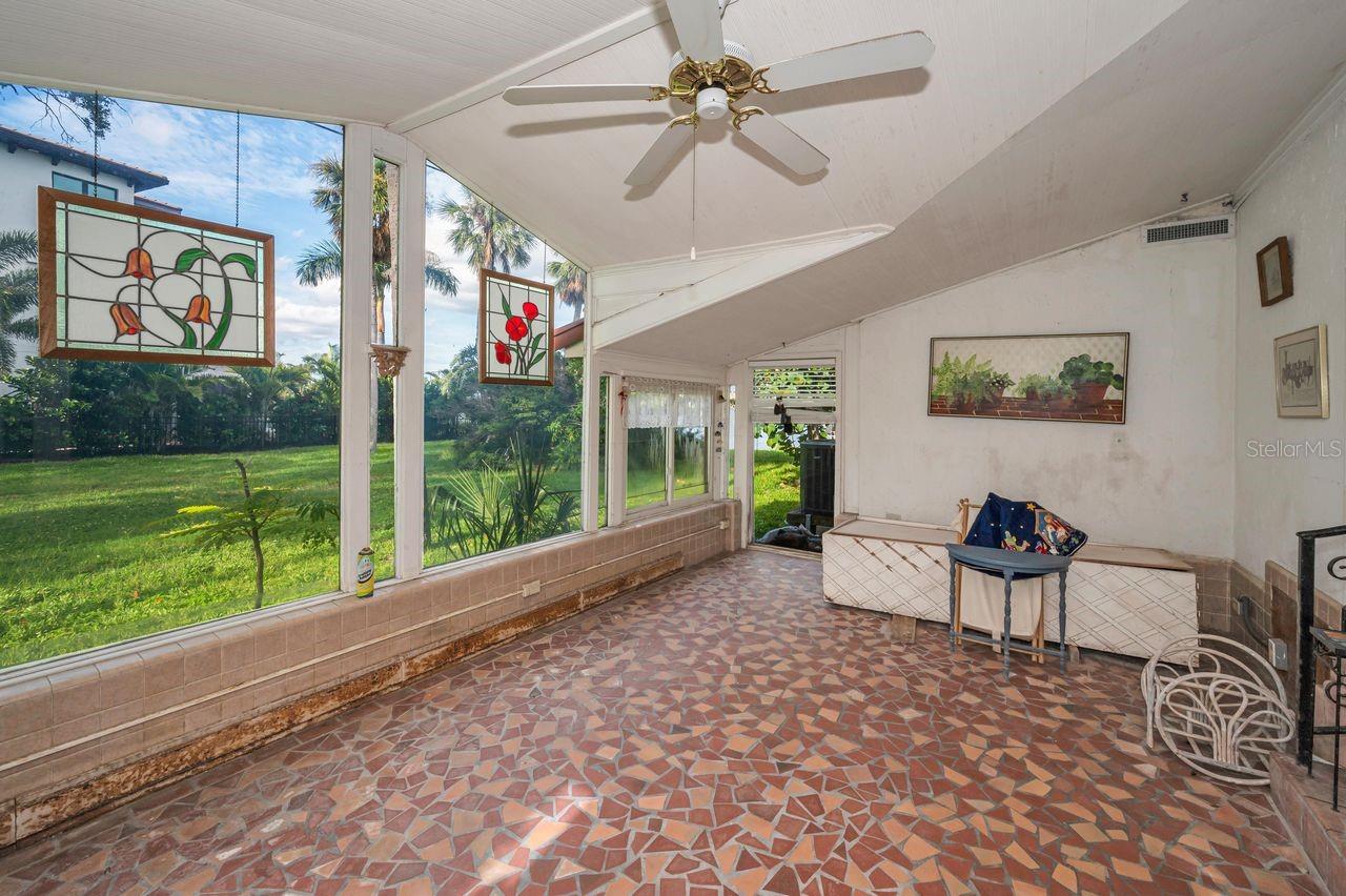 Sunroom offers a view of the spacious side yard and the water.