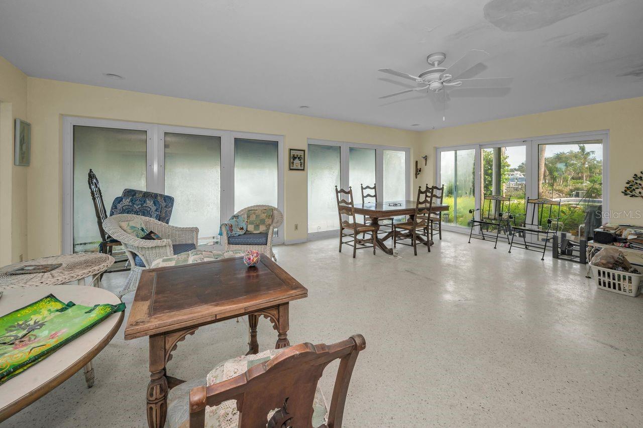 The family room offers views of the pool and outdoor seating areas.