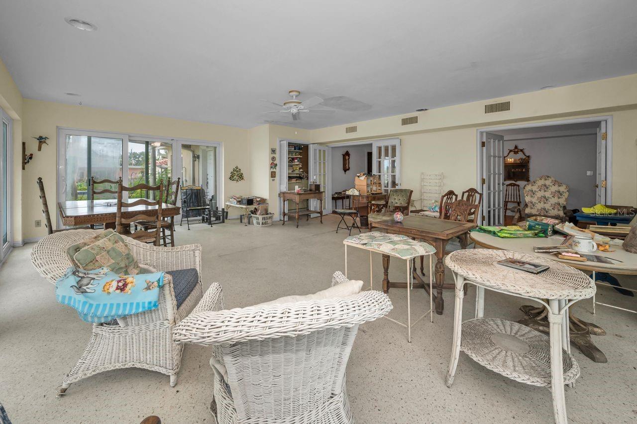 Looking into dining room to the right and out towards the pool area to the left.