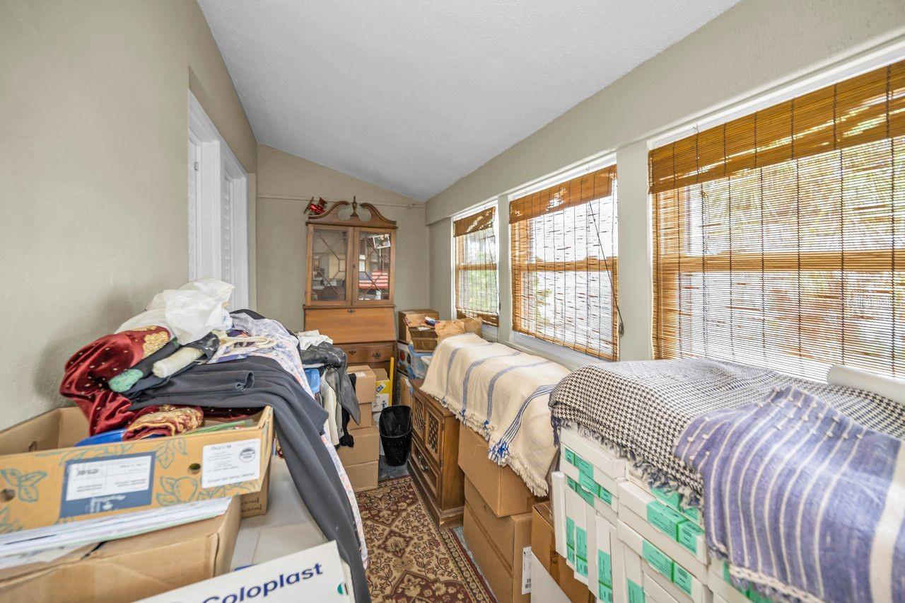 Enclosed porch off of second floor bedroom with water views.