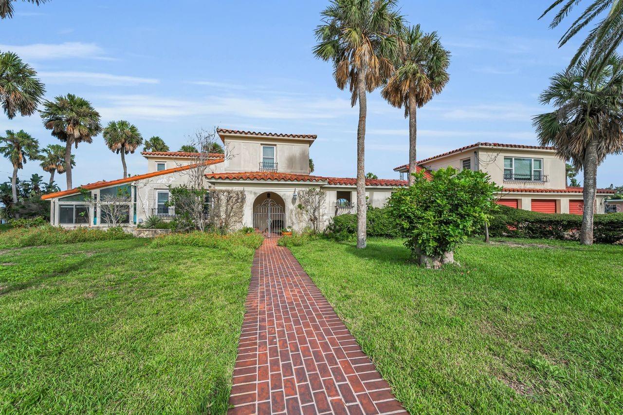 Showcasing the main portion of the home in this photo with the 3 car garage and guest suite to the right.