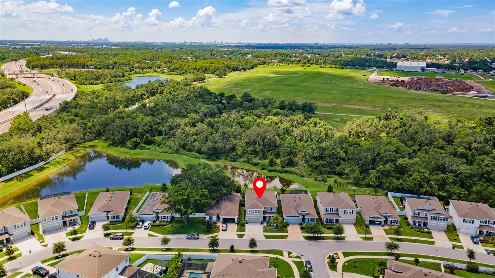 Ariel view front of home with pond and conservation views