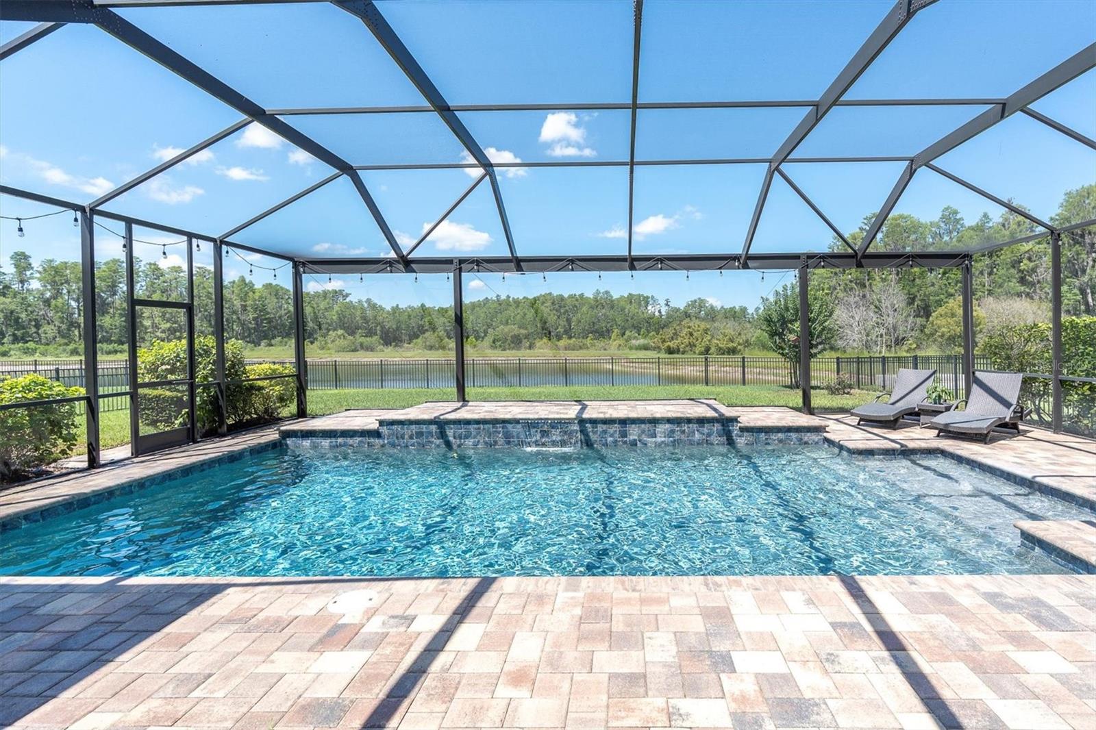 SPARKING 16X28 POOL OVERLOOKING POND & TREES