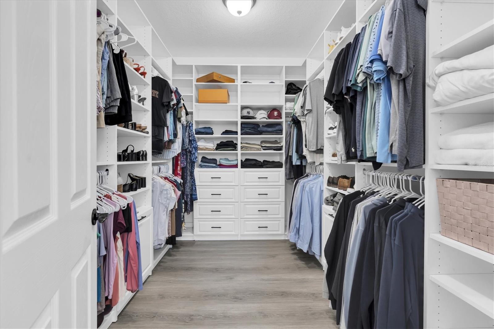 PRIMARY WALK IN CLOSET WITH BUILT IN ORGANIZERS