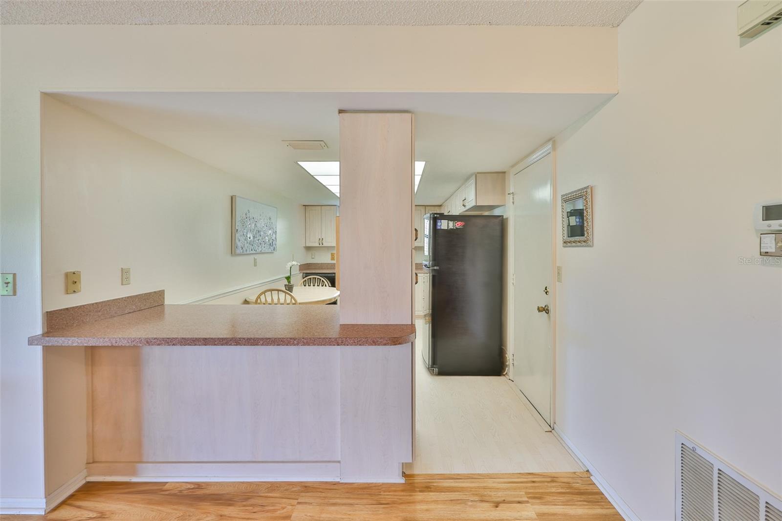 Behind the dining area, a breakfast bar adds additional seating for guests and lots of counter top space.