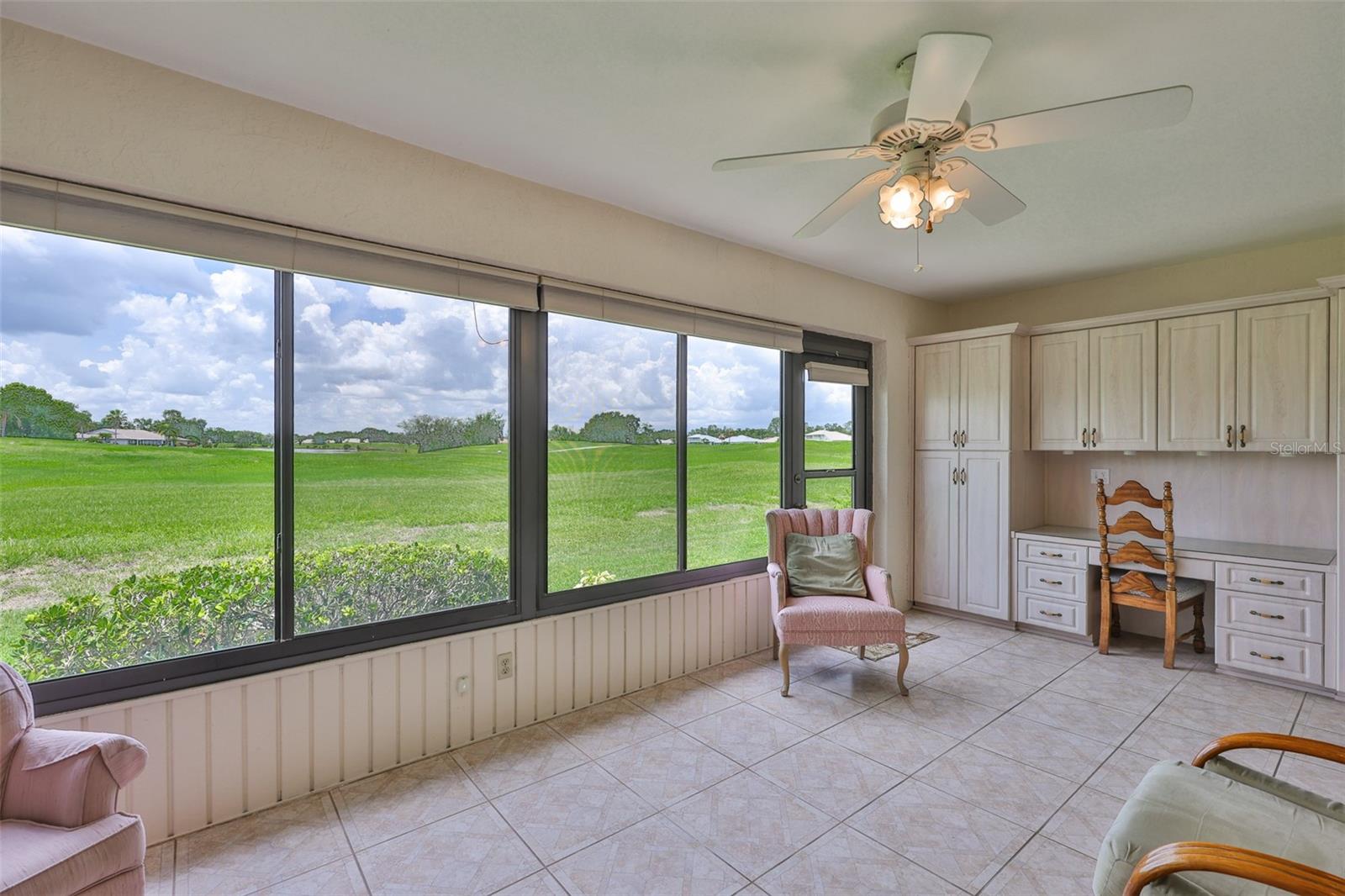Florida room is HUGE and air conditioned, with built-in cabinets/desks on each end.