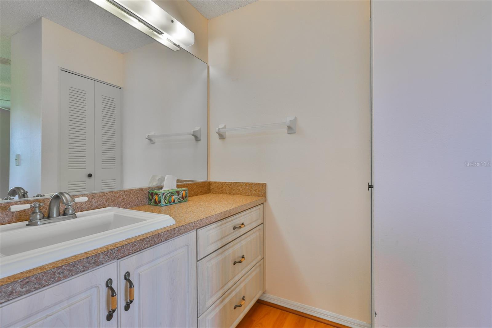 Updated ensuite bathroom with tall cabinetry.