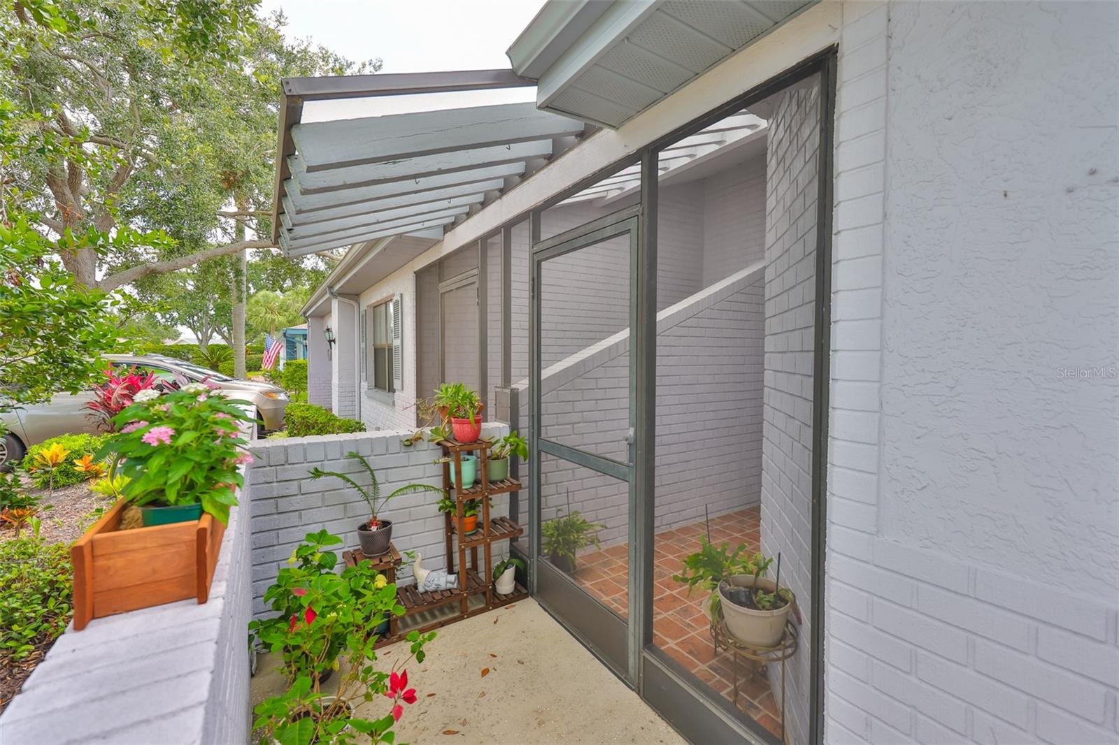 Perfect area for small gardening activities and a screened in front entrance.