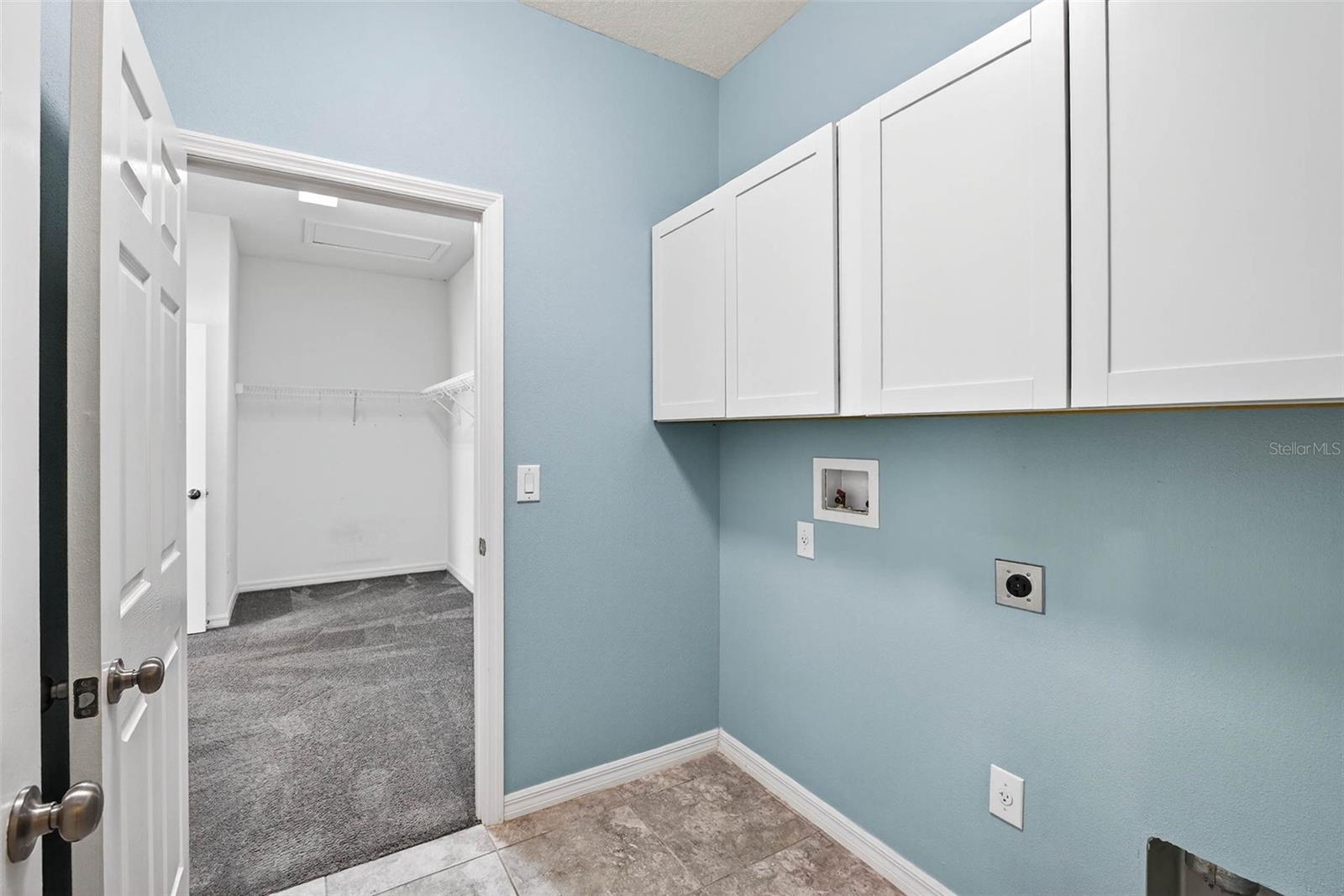 Laundry room directly adjacent to primary bedroom and living area.