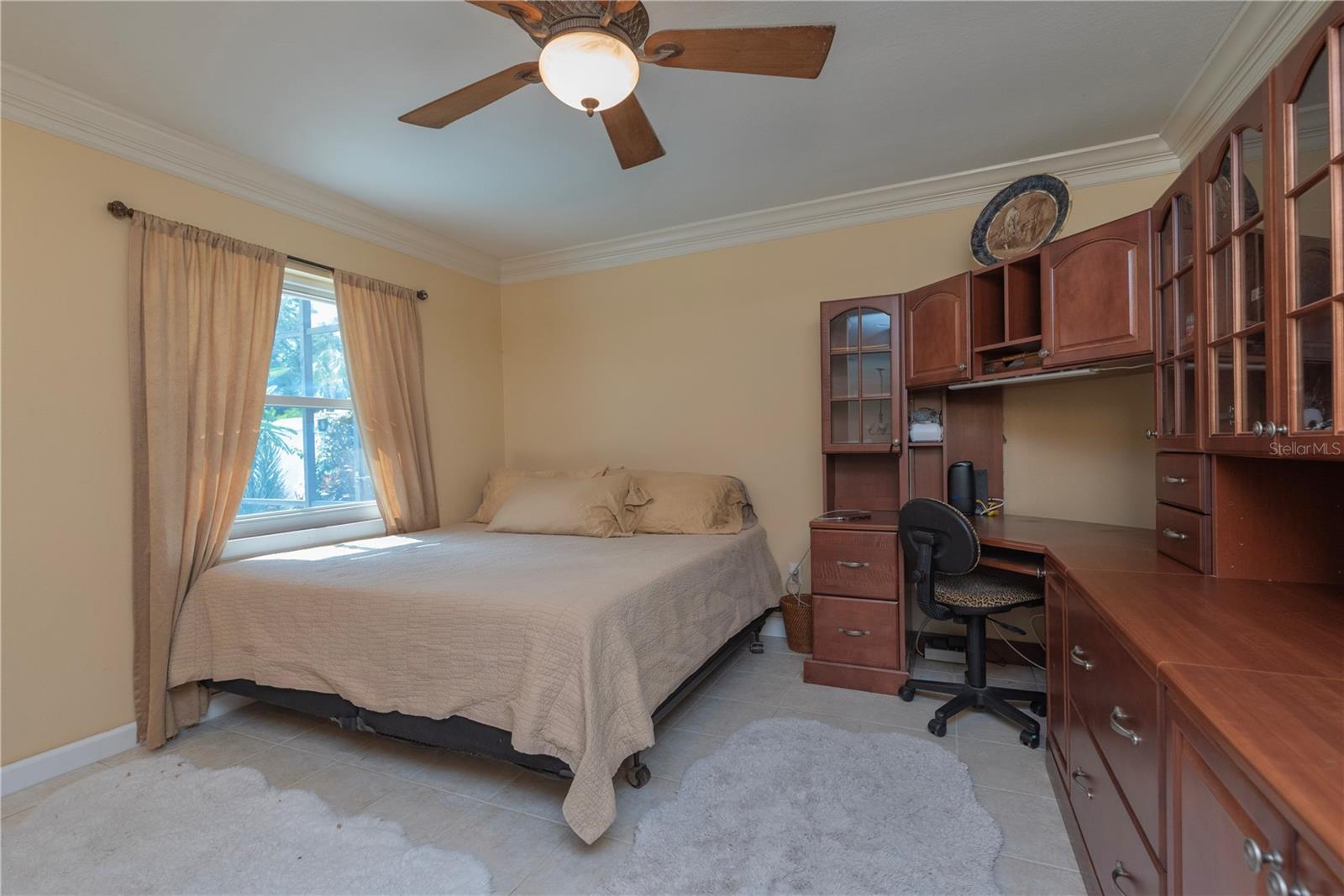Den with built-in desk and shelves.