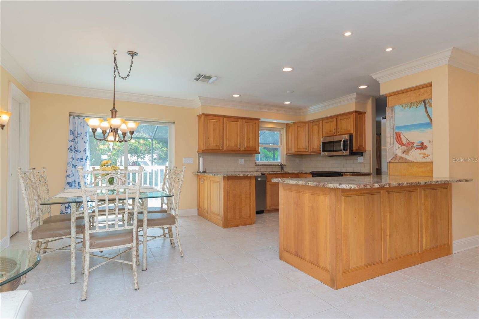 Kitchen with breakfast bar opens to the dining room.