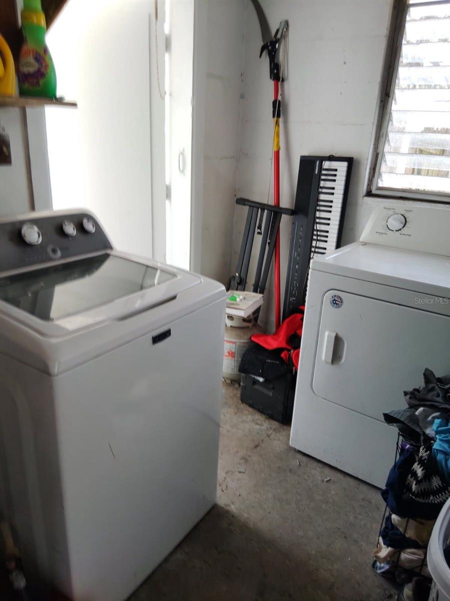 Dedicated utility room equipped with washer and dryer connections.