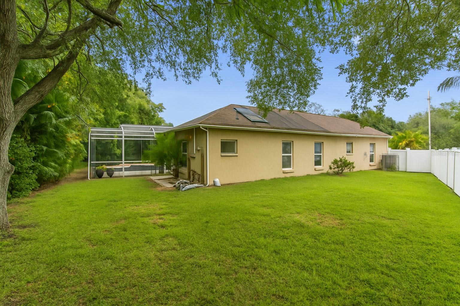 Enjoy ultimate privacy and space in this fully fenced, oversized backyard—ideal for entertaining, gardening, or letting pets roam freely. Surrounded by lush landscaping and shaded by mature trees, this backyard offers plenty of room for a playset, firepit, or future additions. A rare find in a gated community with no rear neighbors and move-in ready convenience.