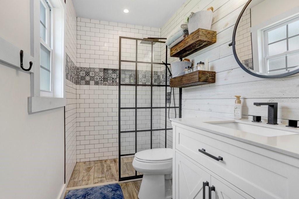 Remodeled Primary Bathroom with barn door to Bedroom